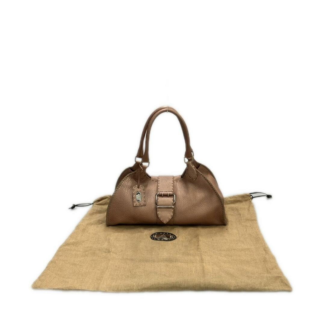 Tan pebbled dome bag shown with its dust bag