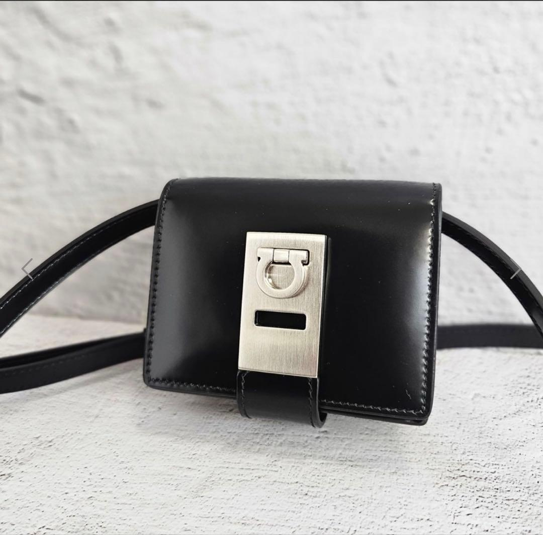 Front view of the black leather Gancini mini wallet-on-strap