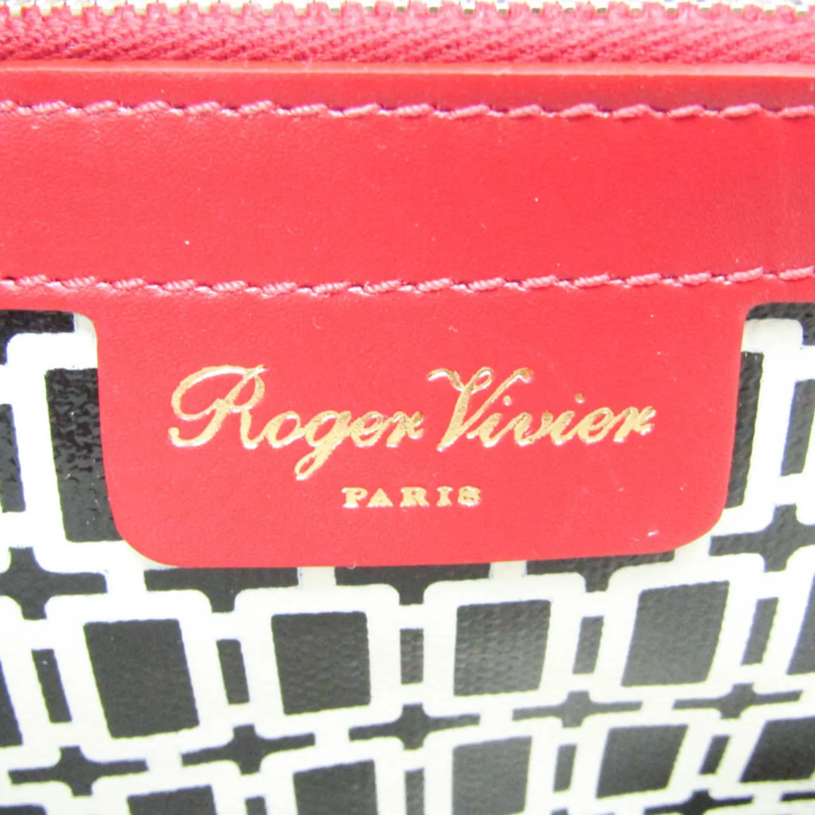 Close-up of the red leather logo tab on the graphic tote