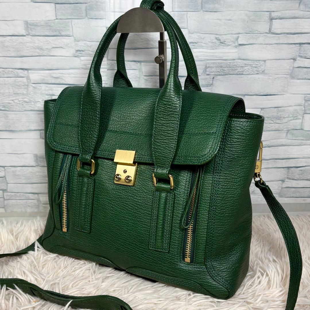 Forest-green structured leather satchel with gold hardware