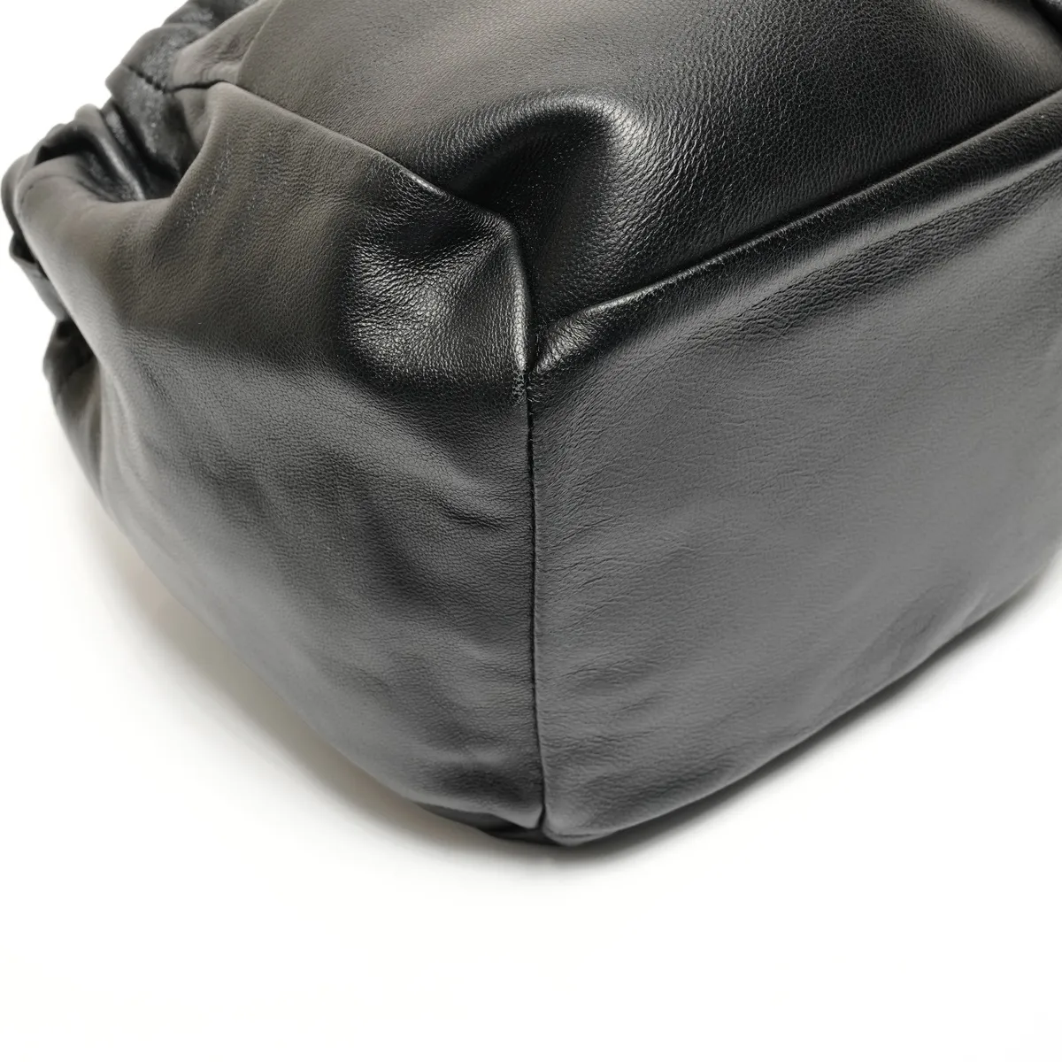 Close view of the black pebbled leather and stitched corner