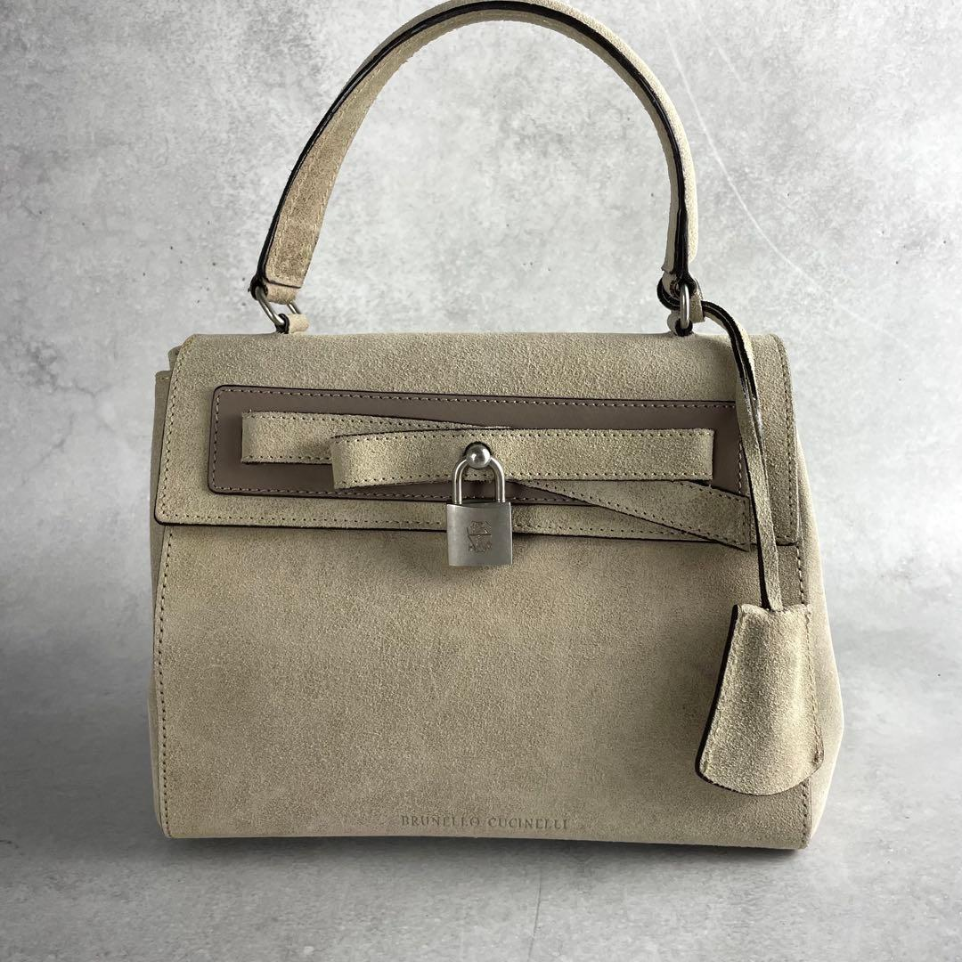 Front view of the stone suede padlock top-handle bag