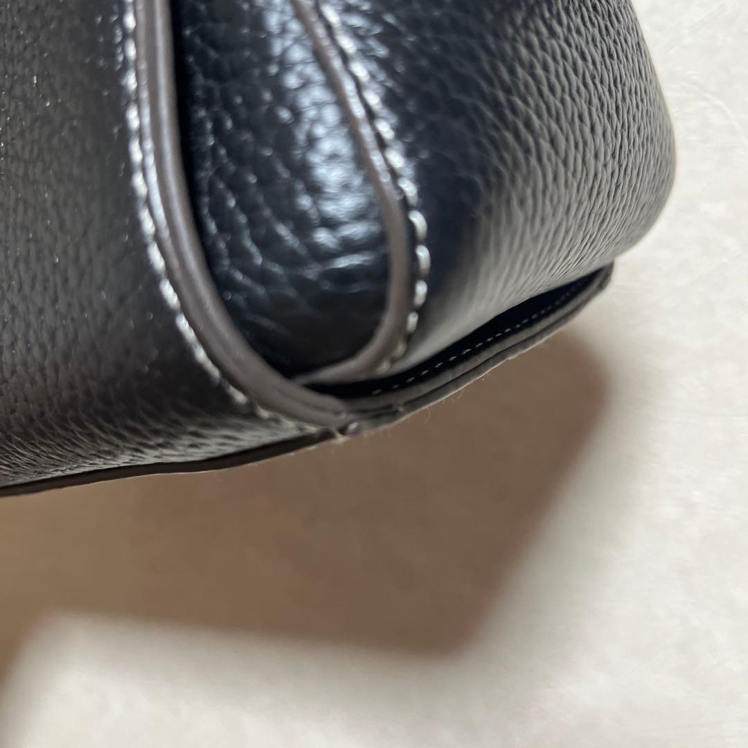 Close view of the black leather corner and white stitching