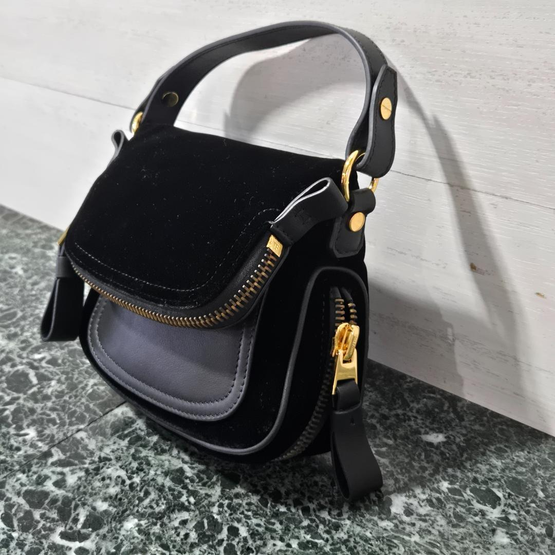Black Tom Ford velvet saddle bag with gold hardware