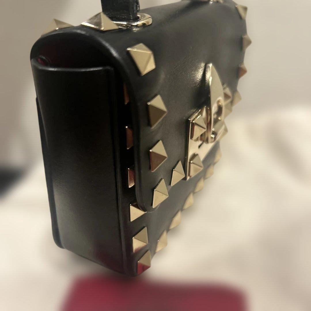 Side profile of the black studded mini bag