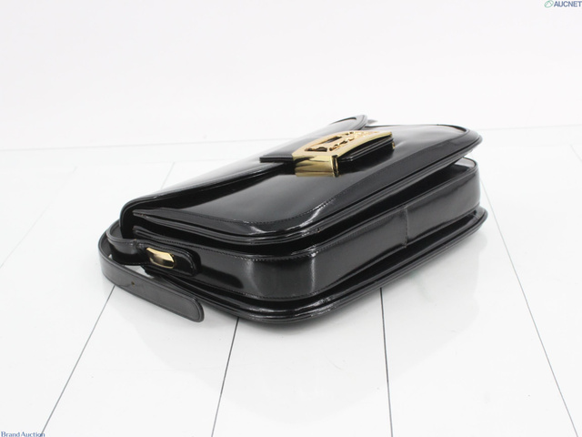Angled view of the patent flap bag and shoulder strap