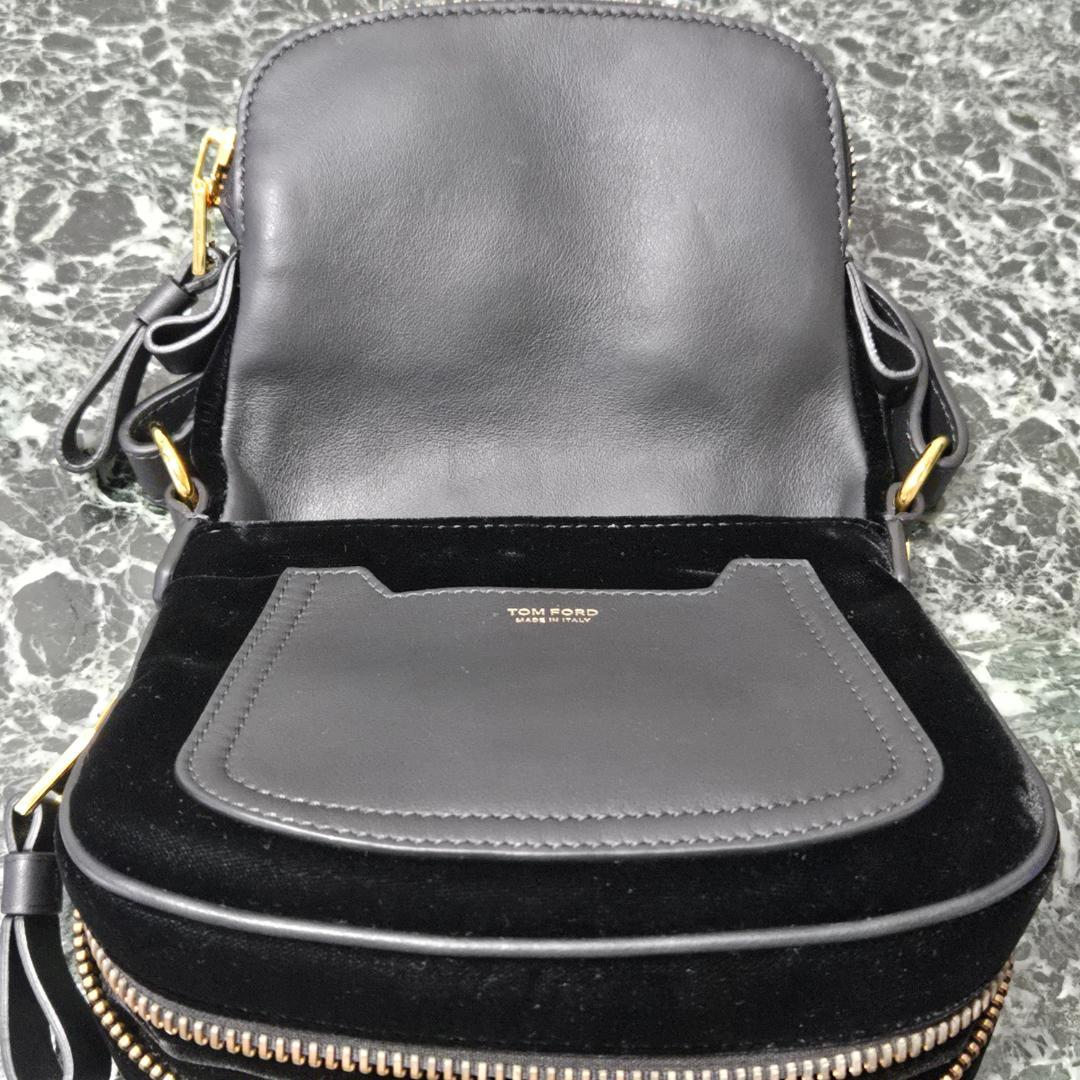 Open saddle bag showing the leather pocket and velvet interior