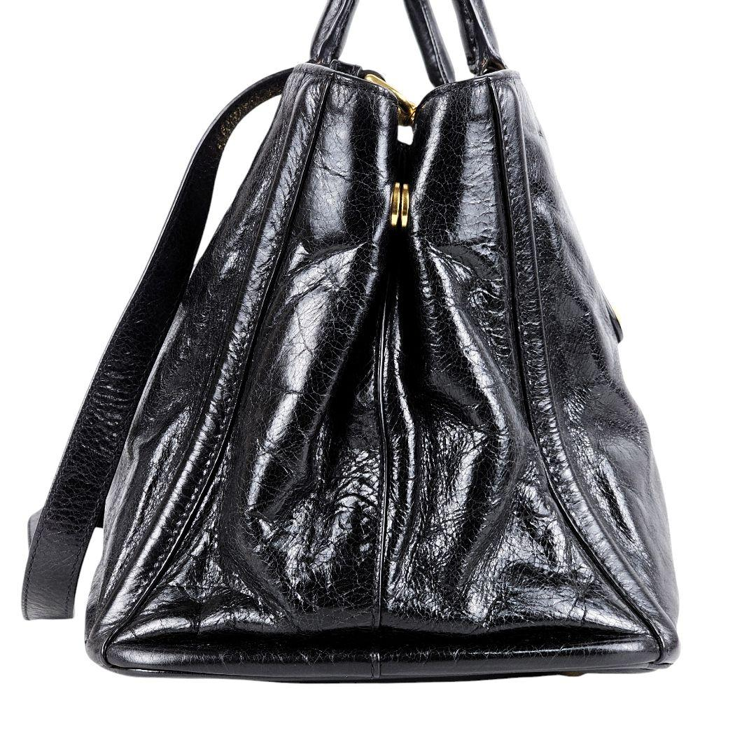 Side profile of the black glossy leather bag