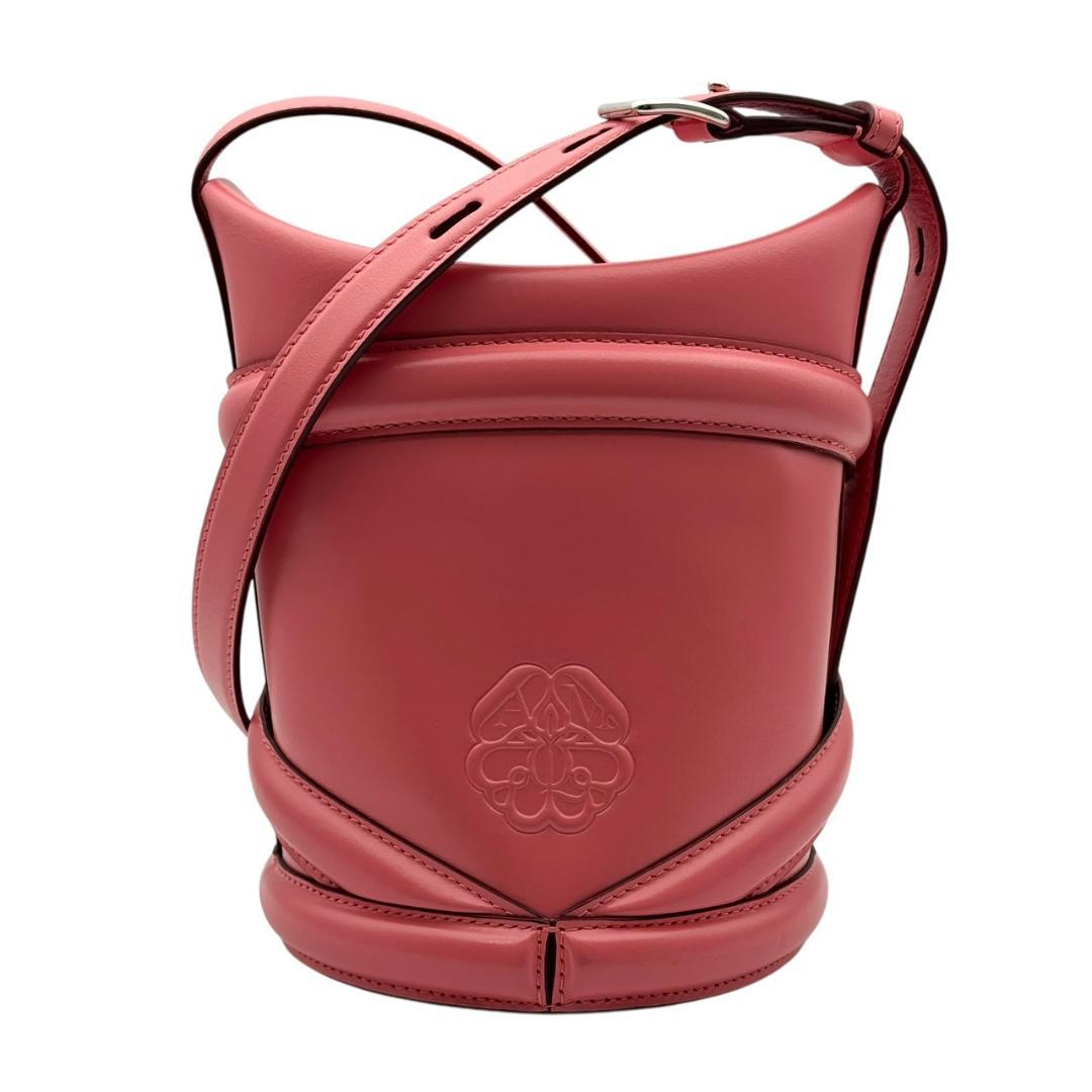 Rose bucket bag with embossed emblem and curved leather bands