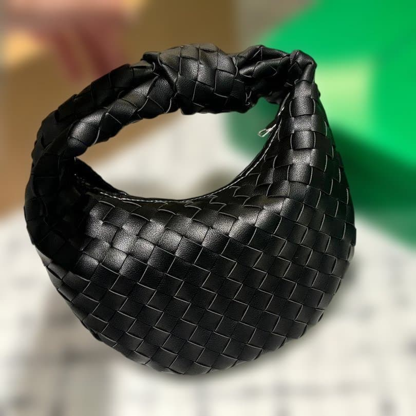 Close view of the black woven leather and knotted handle