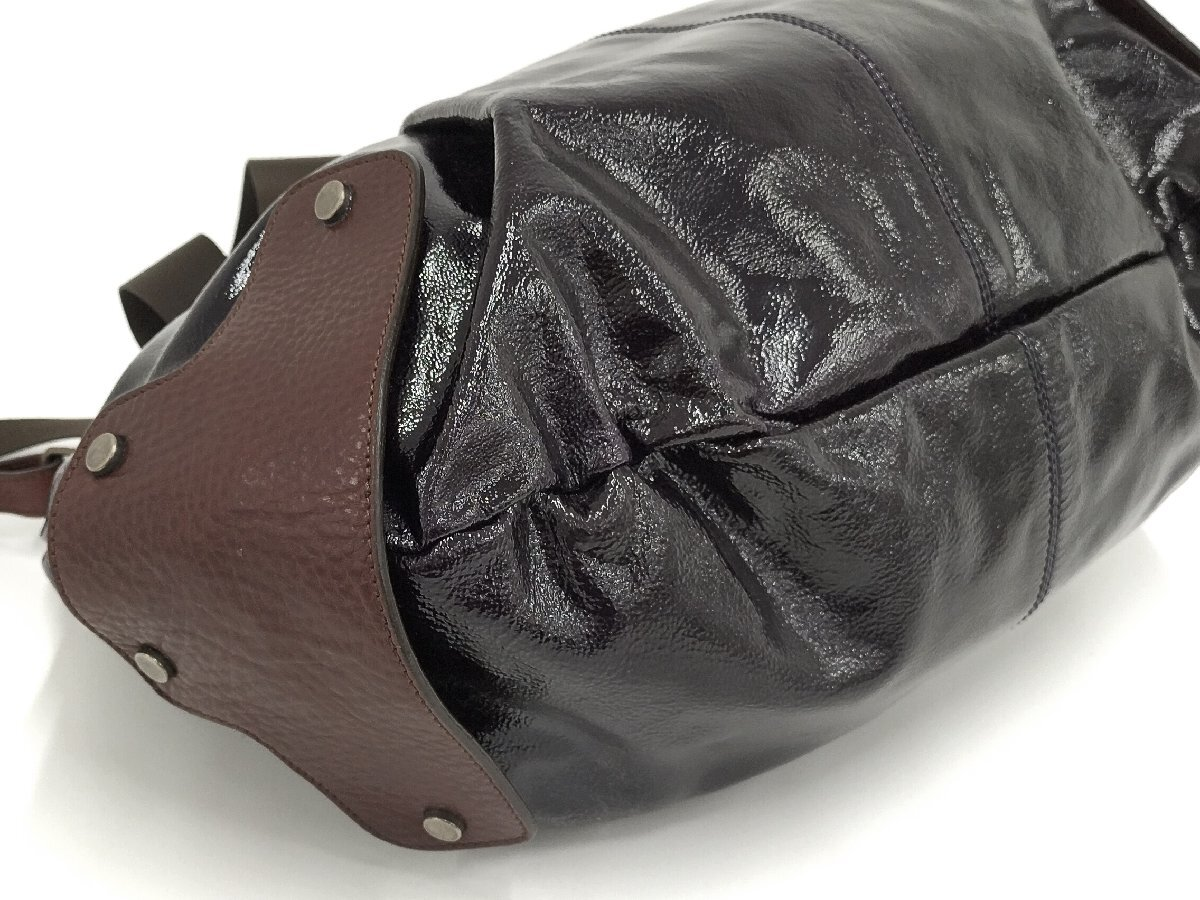 Leather reinforced base and pleated patent body