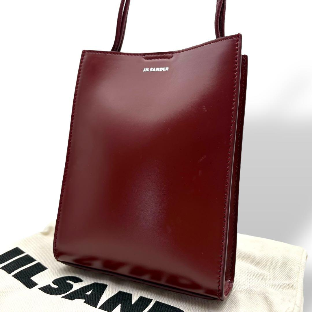 Bordeaux patent mini tote shown with its cotton dust bag