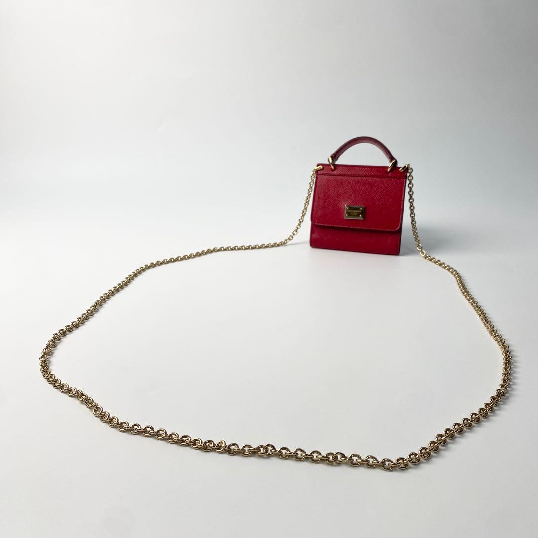 Red miniature bag shown with its full gold chain