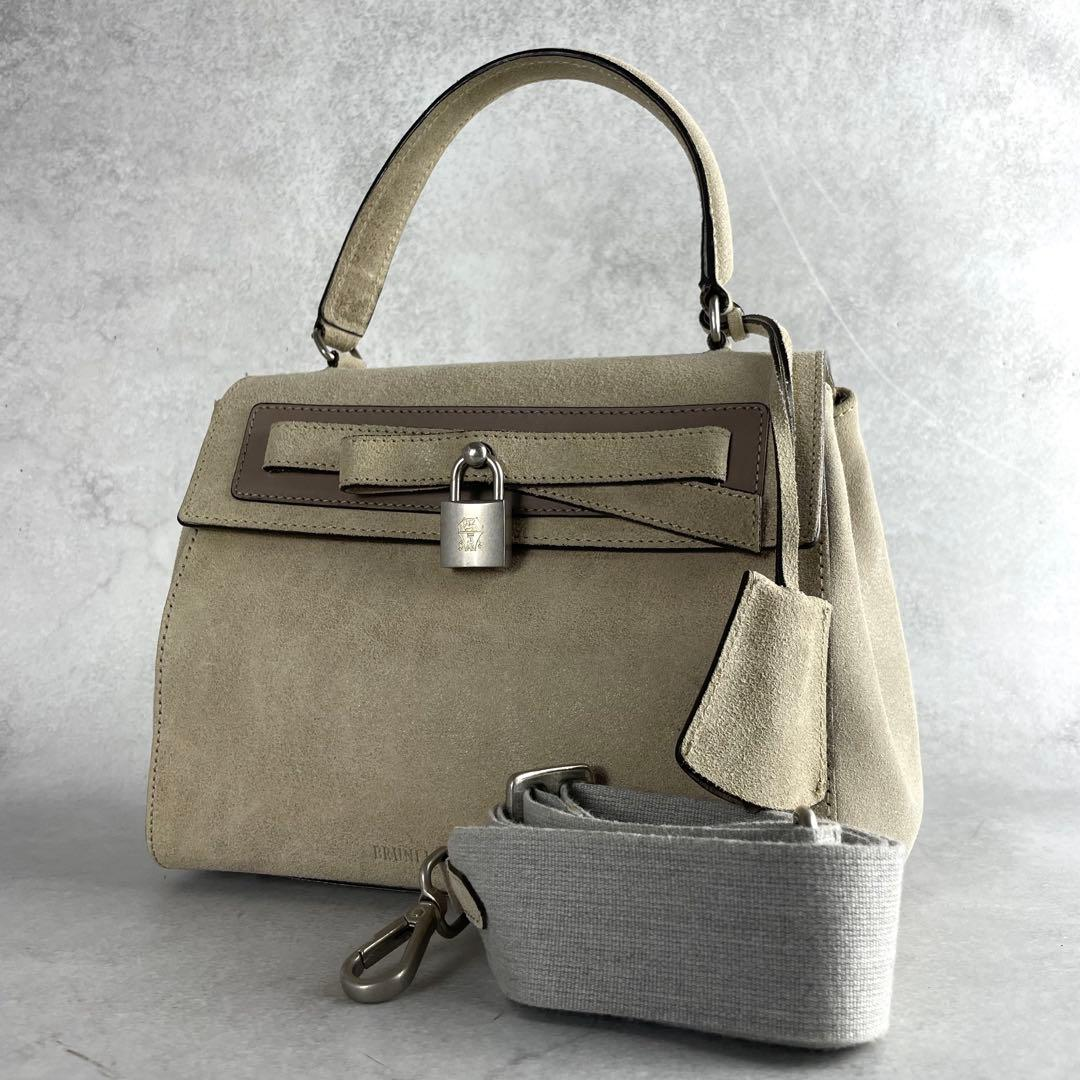 Stone suede padlock bag with its detachable woven strap
