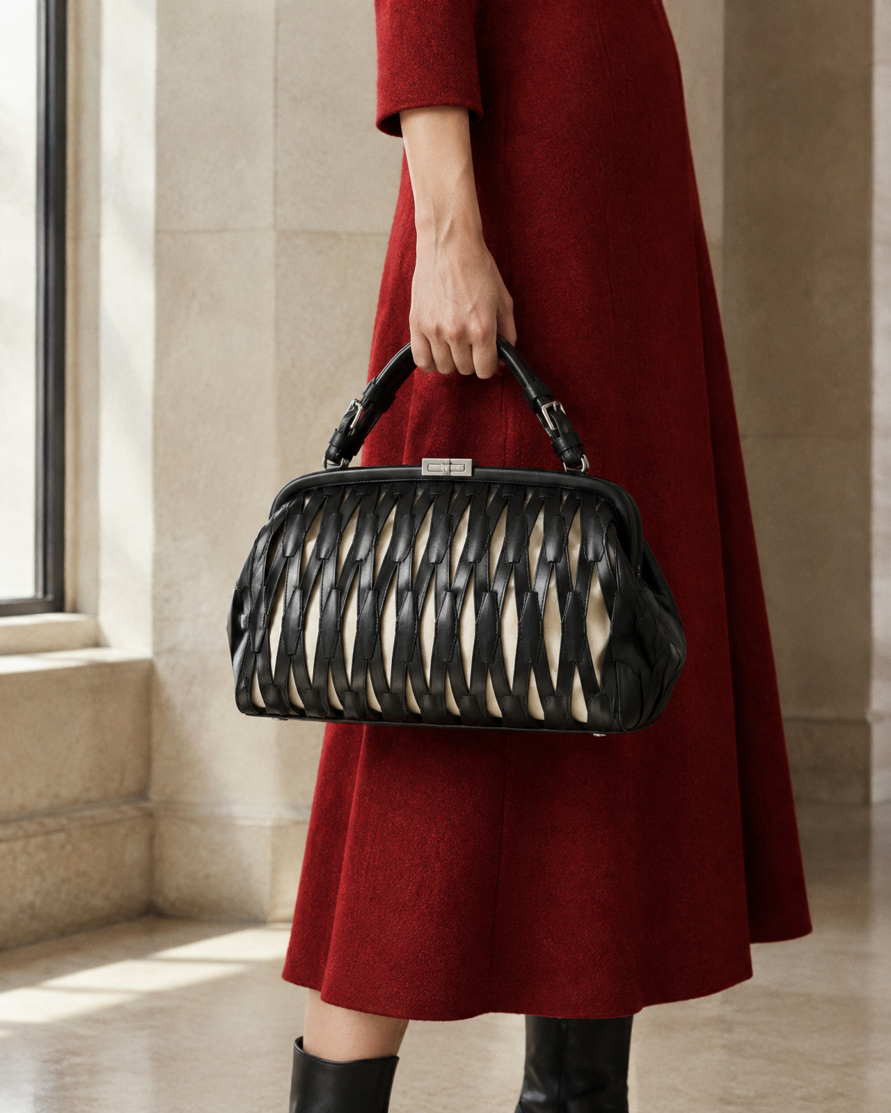 Model carrying the black woven lattice frame bag