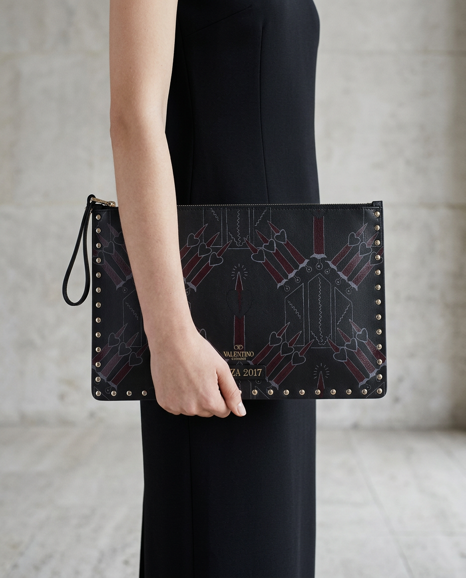 Model holding the black Valentino Ginza 2017 clutch
